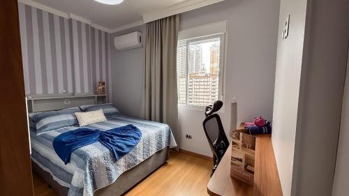 a bedroom with a bed with a blue bow on it at SHB - Central Miramar Shopping Mall from the beach in Santos