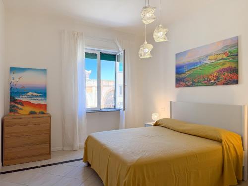 a bedroom with a bed and a window at Piazza 49 - HelloElba in Portoferraio