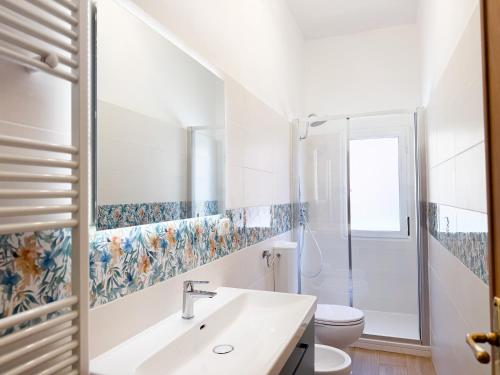 a bathroom with a sink and a toilet at Piazza 49 - HelloElba in Portoferraio