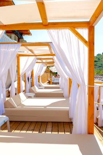 a row of beds on the deck of a boat at Cako Rooms Saranda in Sarandë