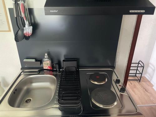 a kitchen counter with a sink and a stove at Grimm Apartment 4 in Kassel