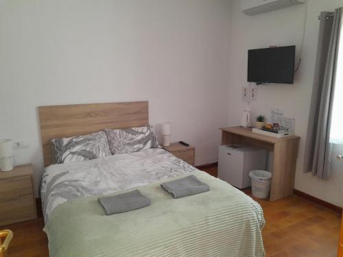 a bedroom with a bed with two pillows on it at DJM Palms - Shared Casa Rural - Casa Rural Compartida - No es una casa privada in Ayora