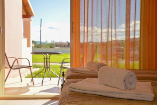a group of towels sitting on top of a porch at Megali Luxuries Apartments in Sidari