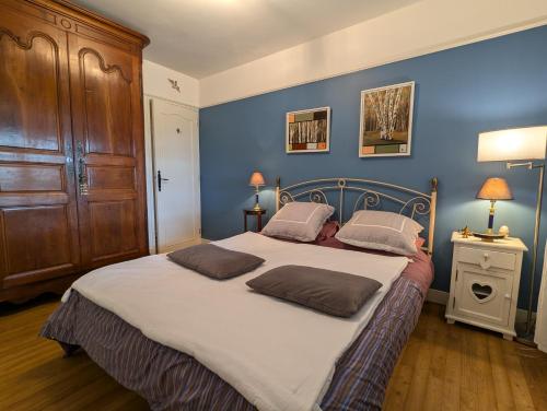 a bedroom with a large bed with two pillows on it at La Chesnaie in Bonnes