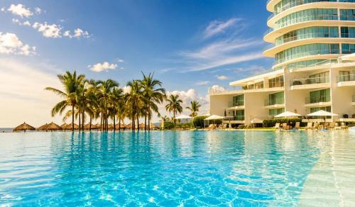 a swimming pool in front of a resort at Aria Ocean in Nuevo Vallarta