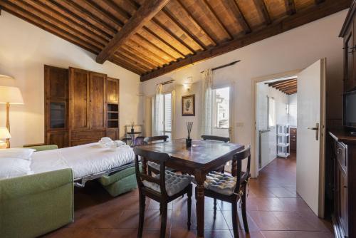 a bedroom with a bed and a table and chairs at Borgo Allegri Palace By MMega in Florence