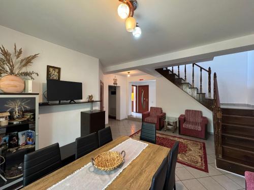a living room with a dining room table and chairs at Casa Alexana in Gura Humorului