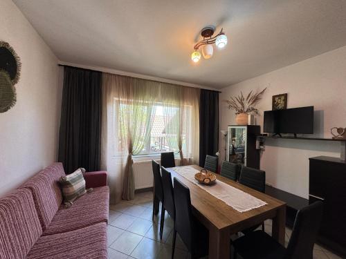 a living room with a table and a couch at Casa Alexana in Gura Humorului