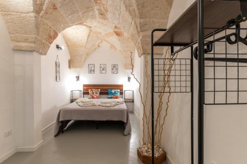 a bedroom with a bed in the middle of a building at Gente di Mare Luxury Home in Fasano