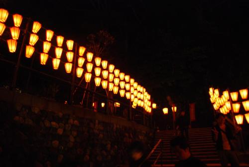 a row of lights on a wall at night at Town Hotel 41 in Kanazawa