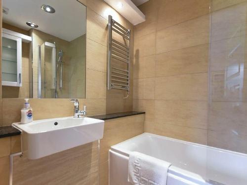 a bathroom with a sink and a bath tub at Northrawe in Bamburgh