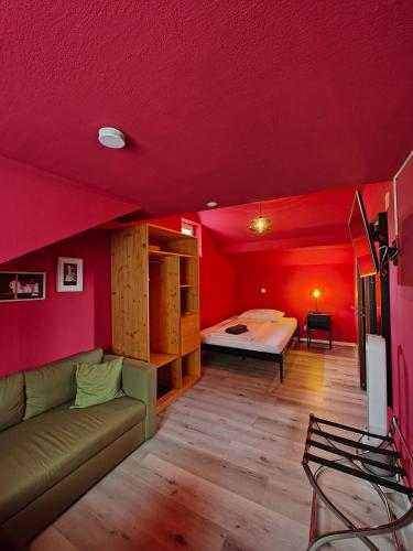 a living room with a couch and a bed in a room at Hotel Freihof in Glarus