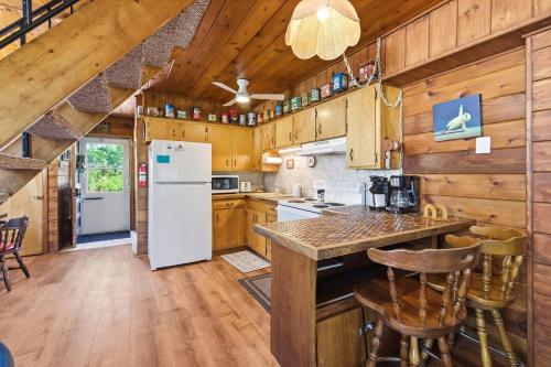 a kitchen with a white refrigerator and wooden cabinets at Chalet #57 in Stevensville