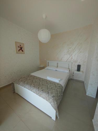 a bedroom with a white bed in a room at Dika Sofia Residence in Mangalia