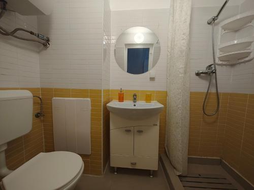 a bathroom with a toilet and a sink and a shower at Dika Sofia Residence in Mangalia