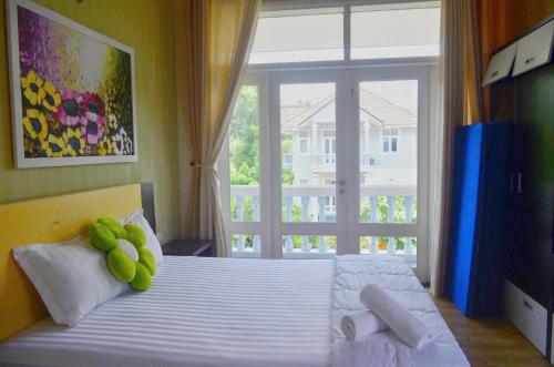 a bedroom with a bed with a stuffed animal on it at Vila Mũi Né-Phan Thiết in Ấp Ngọc Hải