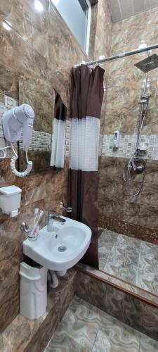 a bathroom with a sink and a shower at Hotel Erebuni Plaza in Yerevan