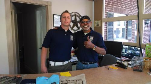 dos hombres parados uno al lado del otro en una oficina en Five Star Inn - Maggie Valley, en Maggie Valley