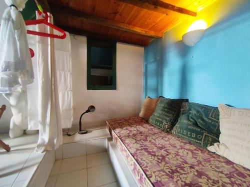 a small room with a bed and a window at Kastro Astypalea Spitaki in Astypalaia