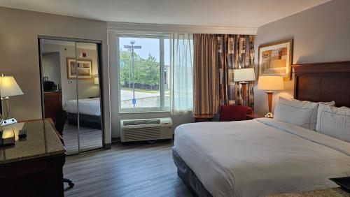 a hotel room with a bed and a large window at DoubleTree by Hilton Jefferson City in Jefferson City