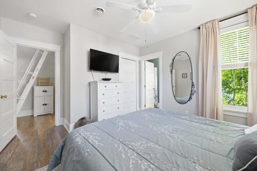 a bedroom with a bed and a tv and a mirror at The Jackrabbit - 3 Summer Village in Cherry Valley