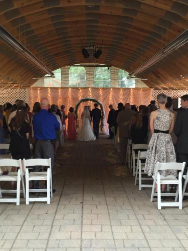 a bride and groom walking down the aisle at their wedding at The Woods Inn in Inlet