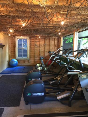 a gym with several exercise bikes in a room at The Woods Inn in Inlet