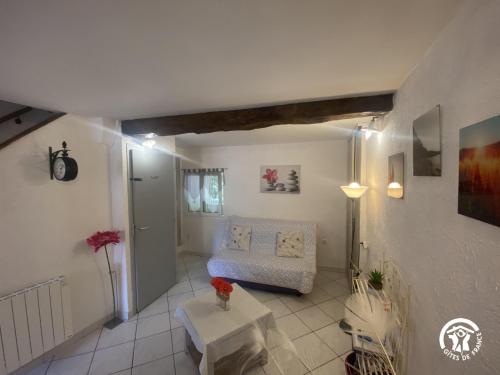 a living room with a couch and a table at La paraguère in Sorède