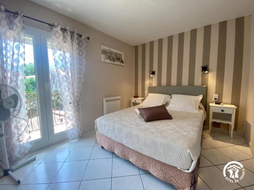a bedroom with a bed and a window at La paraguère in Sorède