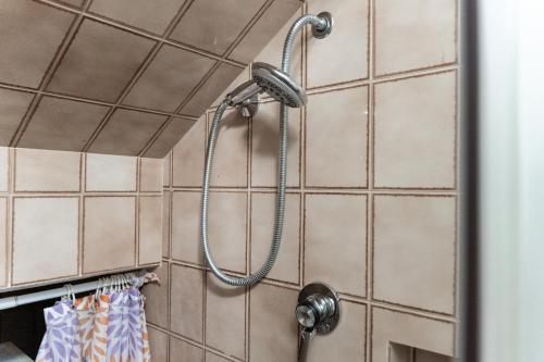 a shower in a bathroom with tiles at Pugliaholidayplus - IL VILLONE NEL BOSCO in Polignano a Mare