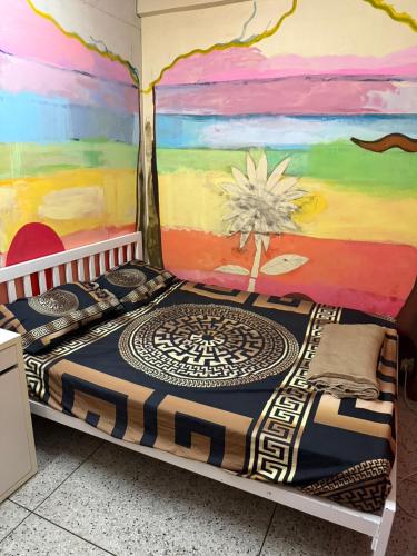 a bed in a room with a mural on the wall at W District hostel in Bangkok