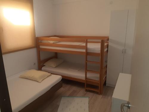 a small room with two bunk beds in it at Apartman Almira in Donji Štoj