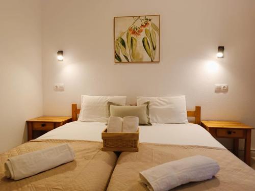 a bedroom with a bed with two pillows on it at Elena Apartments in Keramoti