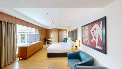 a hotel room with a bed and a chair at Svelte Delhi, a member of Radisson Individuals in New Delhi