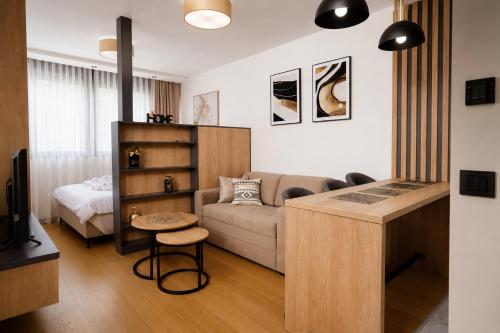 a living room with a couch and a table at Hedonist Wellness & Spa in Zlatibor