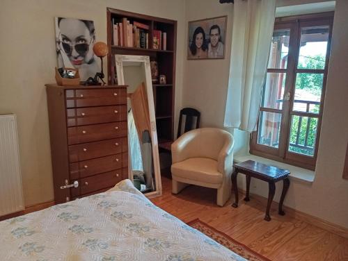 a bedroom with a bed and a chair and a dresser at Deli House in Promírion