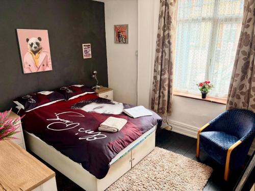 a bedroom with a bed and a chair in it at Ramsgate Corner Retreat in Ramsgate