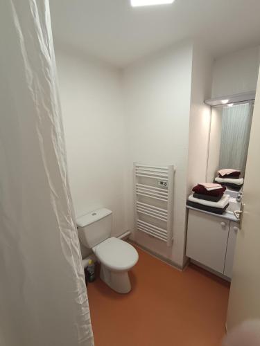a bathroom with a white toilet and a sink at Au refuge de Rolf in Calvisson