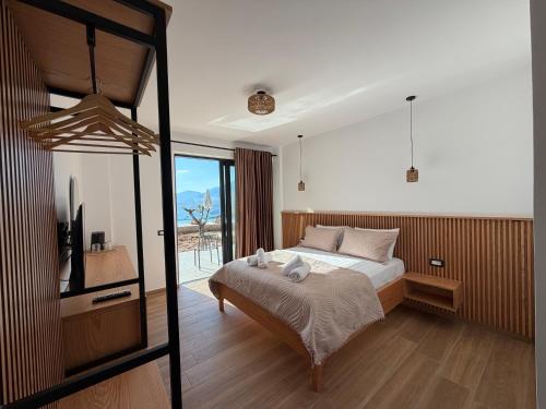 a bedroom with a bed and a television in it at Filikuri Boutique Hotel in Himare