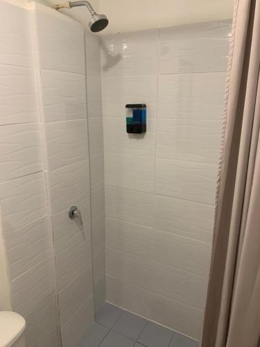 a bathroom with a shower with a glass door at Hotel Casa Lucca in Medellín