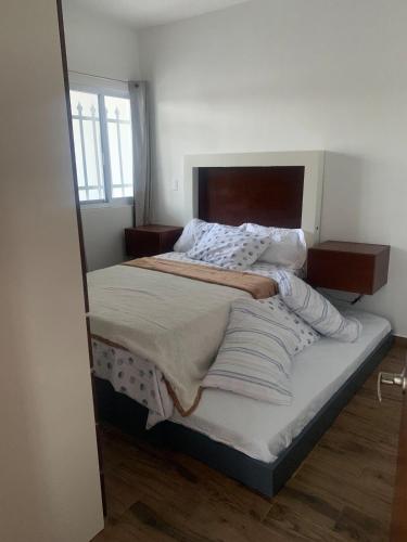 a large bed in a room with a window at Comoda y hermosa casa MINDY in Tuxpan de Rodríguez Cano