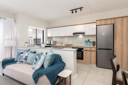 a living room with a couch and a kitchen at Ballito Hills 478 in Ballito