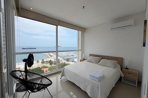 a bedroom with a bed and a large window at Eira by Colproperty Management in Santa Marta