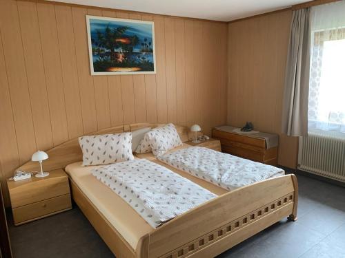 a bedroom with a large bed and a window at Ferienhaus Erika in Telfs