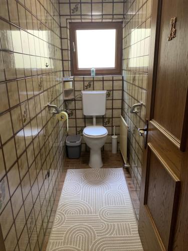 a small bathroom with a toilet and a window at Ferienhaus Erika in Telfs