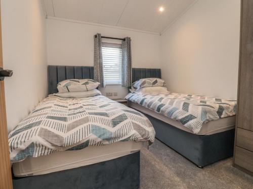 two twin beds in a room with a window at Number 35 in Blackburn