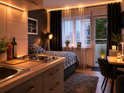 a kitchen with a bed and a sink in a room at Bellevue Residence l City Balkon in Koblenz