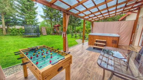 a patio with a pool table and a chess board at Urocza Kryjówka ze SPA in Lesko