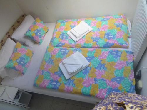 a group of three beds with towels on them at Oleander B&B in Siófok