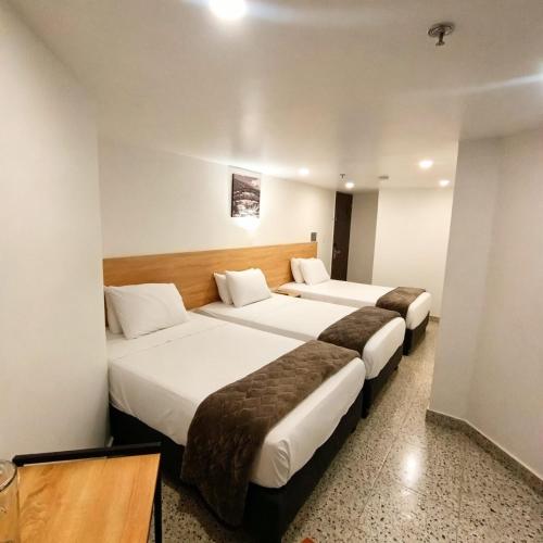 a couple of beds in a hotel room at Bianco Hotel Boutique in Cúcuta